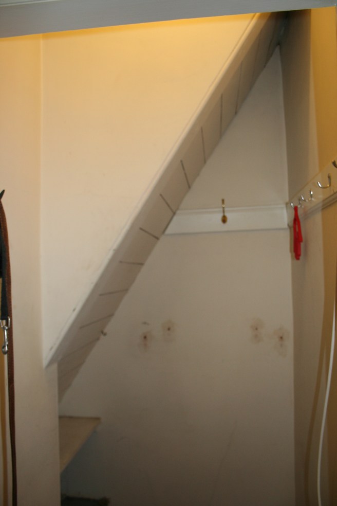 Coat cupboard before with underneath of stairs